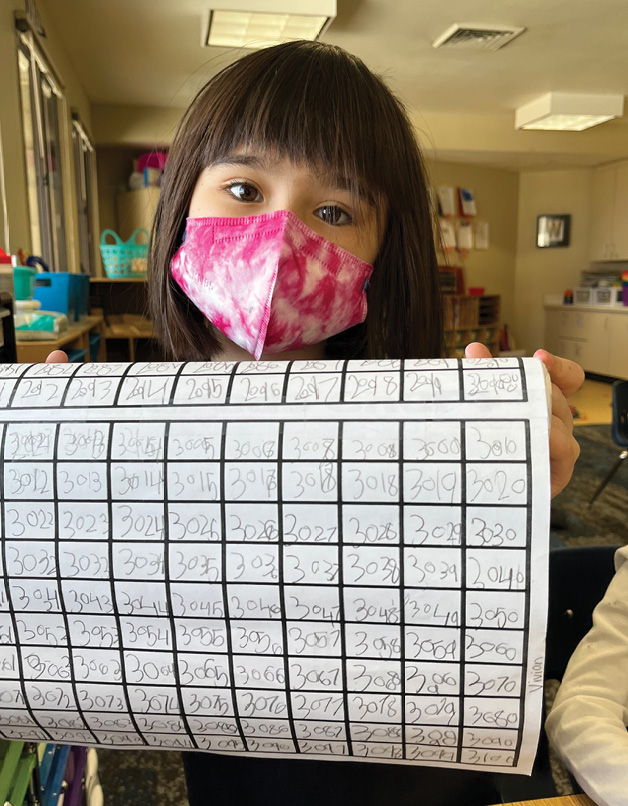 Vivian ’34 shows off her latest math project: counting up to 3100!